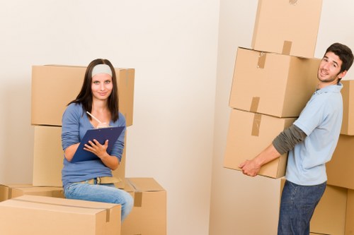 Trained removals staff handling packed boxes carefully