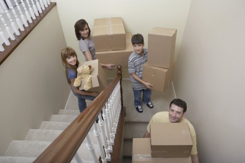 Removal team transporting desks and files through a central London workspace